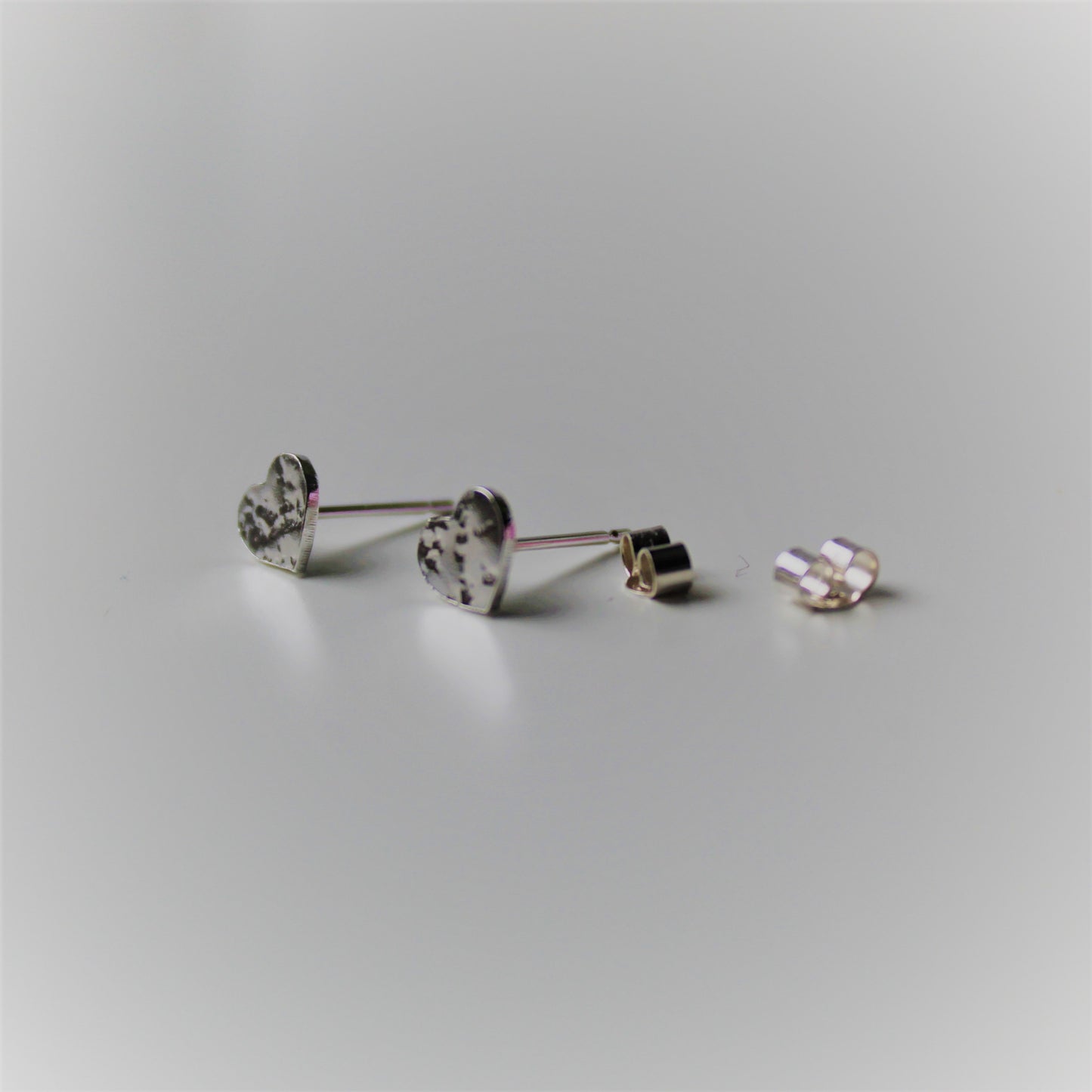 Shine On Sterling Silver Studs, Heart Earrings on White background