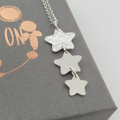 Silver star-shaped necklace on a Shine On gift box