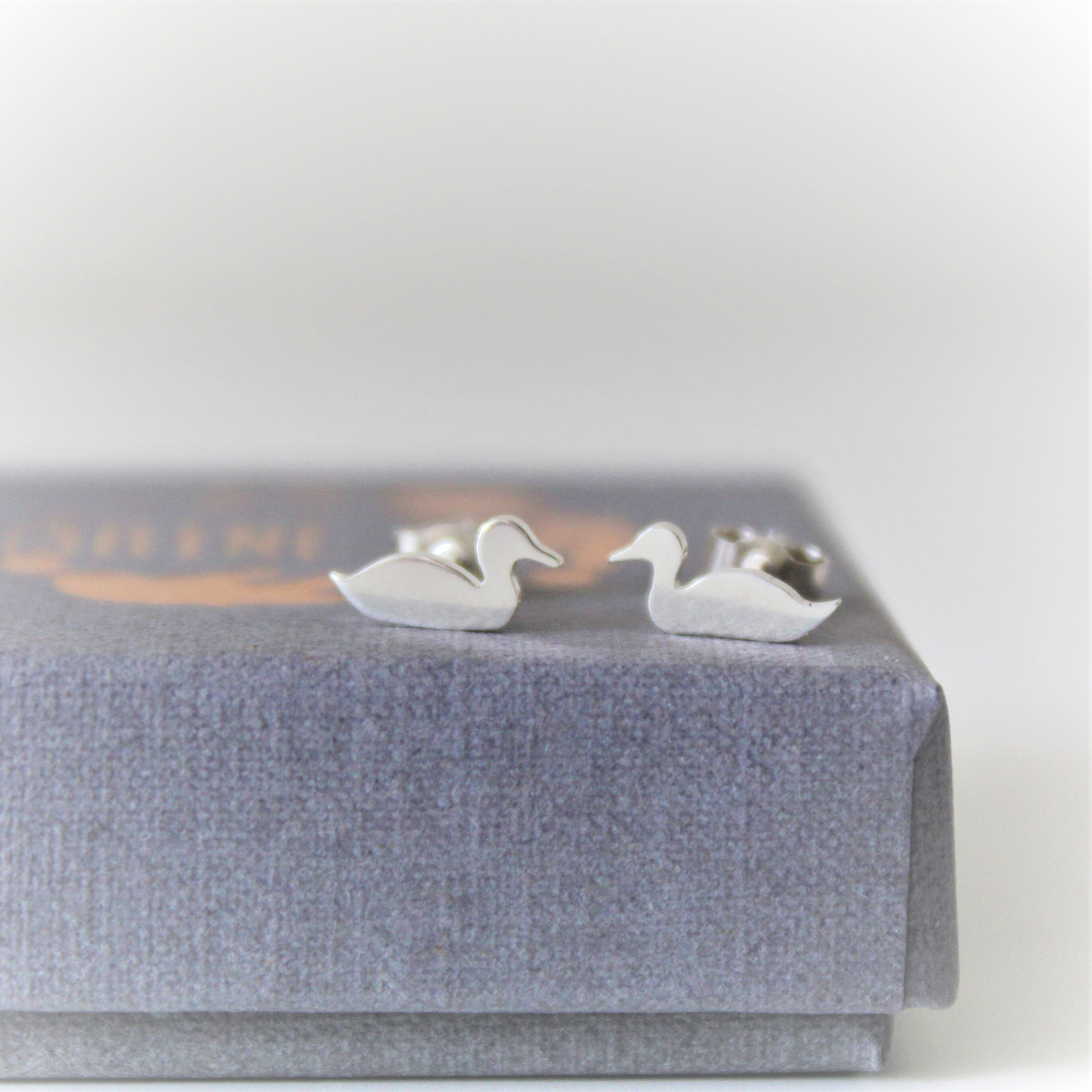Tiny Sterling Silver Duck Earrings on gift box
