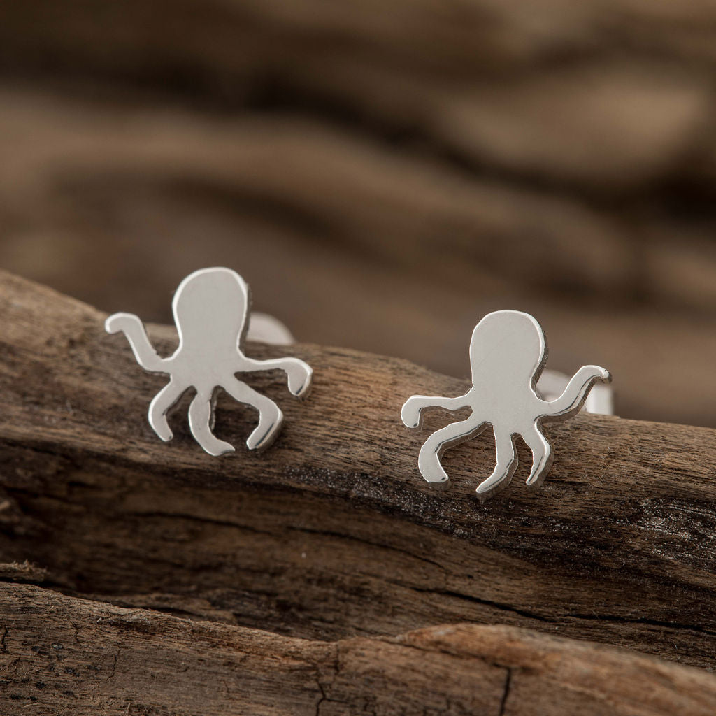 Sterling Silver Octopus Earrings on wooden background
